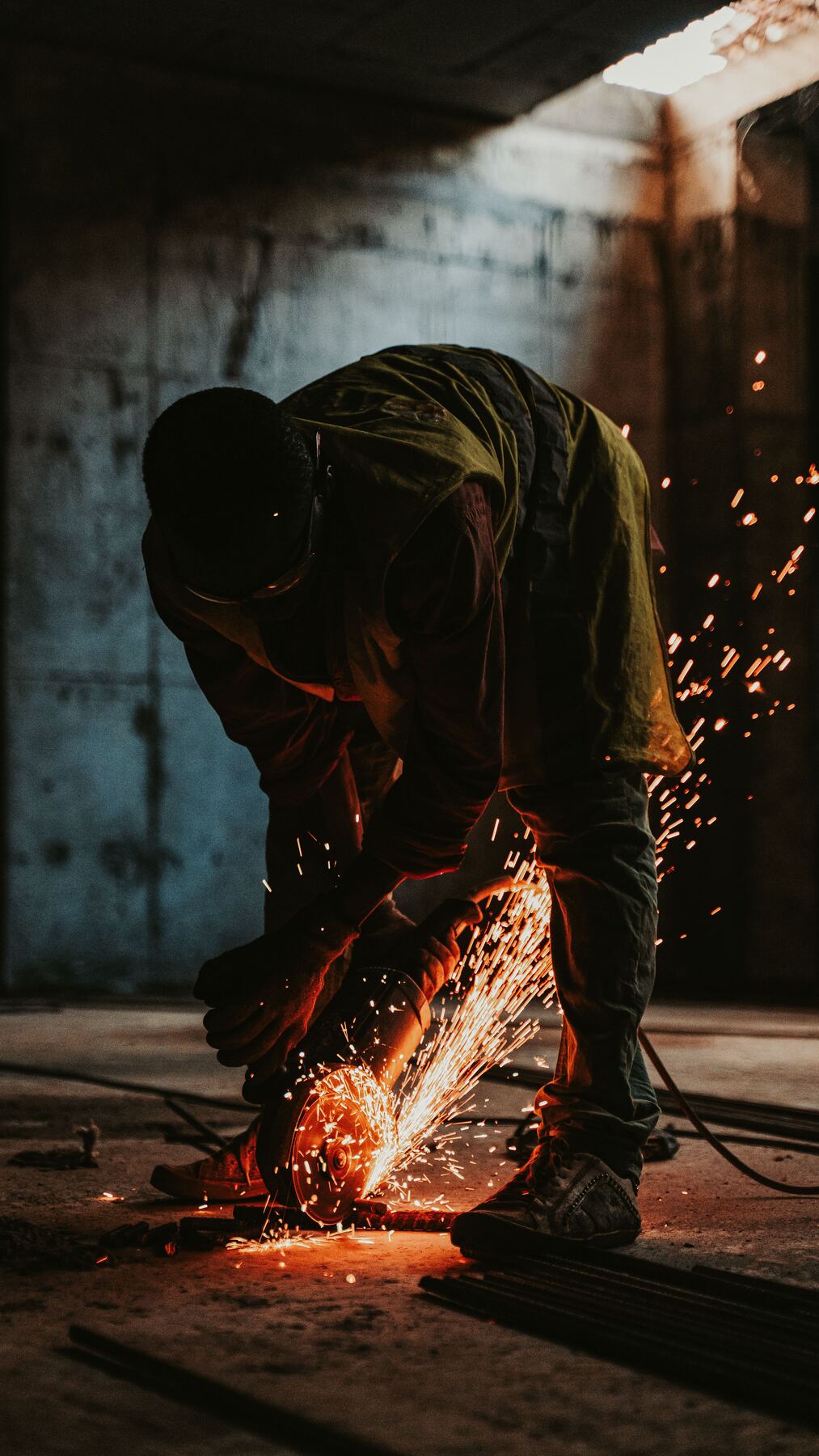 Restoration worker cutting through damaged material